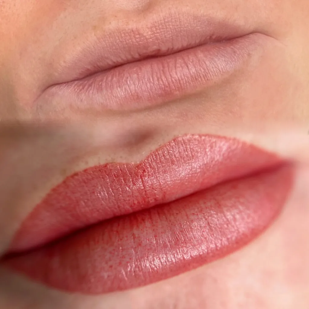 Lip blush before and after — coral-red lower crop against pale upper, mouth macro
